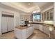 Spacious kitchen with white countertops, a kitchen island, and modern appliances at 7728 E Mary Sharon Dr, Scottsdale, AZ 85266