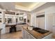 Spacious kitchen with modern cooktop island, granite countertops, and custom cabinetry at 7728 E Mary Sharon Dr, Scottsdale, AZ 85266