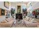 Bright living room with high ceilings, fireplace, and decorative artwork at 7728 E Mary Sharon Dr, Scottsdale, AZ 85266
