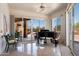 Bright music room with sliding glass doors, desert views, and a grand piano at 7728 E Mary Sharon Dr, Scottsdale, AZ 85266