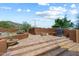 Outdoor area with steps leading to a grill and a fire pit, complete with desert landscape and a mountain backdrop at 7728 E Mary Sharon Dr, Scottsdale, AZ 85266