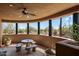 Inviting outdoor patio with tiled flooring, a ceiling fan, and a charming stone table set at 7728 E Mary Sharon Dr, Scottsdale, AZ 85266
