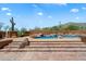 Sparkling pool and desert landscaping with steps leading down to the pool deck with lounge area at 7728 E Mary Sharon Dr, Scottsdale, AZ 85266