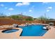 Heated pool and spa surrounded by desert landscape and providing stunning views of the adjacent mountains at 7728 E Mary Sharon Dr, Scottsdale, AZ 85266