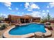 A refreshing pool and spa set against a warm desert backdrop under a bright, cloudy sky at 7728 E Mary Sharon Dr, Scottsdale, AZ 85266