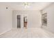 Bright, empty bedroom with tile flooring, a ceiling fan, and ensuite access to a bathroom at 8802 E University Dr # 28, Mesa, AZ 85207