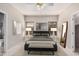 Staged primary bedroom featuring neutral tones, tile flooring, and ample natural light at 8802 E University Dr # 28, Mesa, AZ 85207
