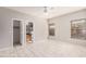 Empty bedroom with tile floors, ceiling fan, and ensuite bathroom and closet access at 8802 E University Dr # 28, Mesa, AZ 85207