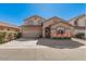 Charming two-story home featuring a well-manicured lawn and a two-car garage under a clear blue sky at 8802 E University Dr # 28, Mesa, AZ 85207