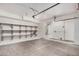 Clean, empty garage space with storage shelves, water heater, and access door at 8802 E University Dr # 28, Mesa, AZ 85207