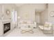 Bright living room with fireplace, white furnishings, and gold accents for a modern, elegant feel at 8802 E University Dr # 28, Mesa, AZ 85207
