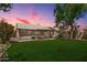 Spacious backyard featuring a lush lawn, pergola, and mature trees, perfect for outdoor entertaining at 9135 W Hazelwood St, Phoenix, AZ 85037