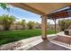 Enjoy the covered patio with paved stones leading to the grassy backyard, offering a tranquil outdoor space at 9135 W Hazelwood St, Phoenix, AZ 85037