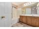 Bathroom with bathtub, shower, and double sink at 9135 W Hazelwood St, Phoenix, AZ 85037