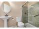 Cozy bathroom featuring a pedestal sink and a modern shower at 9135 W Hazelwood St, Phoenix, AZ 85037