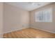 Bedroom with wood look flooring, ceiling fan and window with shutters at 9135 W Hazelwood St, Phoenix, AZ 85037