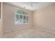 Bedroom with tile flooring, ceiling fan, window with shutters and light peach colored walls at 9135 W Hazelwood St, Phoenix, AZ 85037