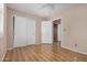 Bedroom with wood look flooring and closet with double doors at 9135 W Hazelwood St, Phoenix, AZ 85037