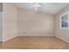 Bedroom with wood look flooring, ceiling fan, and window with shutters at 9135 W Hazelwood St, Phoenix, AZ 85037