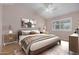 Bedroom with modern furniture, wood look flooring, and window with shutters at 9135 W Hazelwood St, Phoenix, AZ 85037