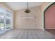 Bright dining space featuring backyard access, neutral walls and tile floors at 9135 W Hazelwood St, Phoenix, AZ 85037