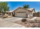 Home featuring a two-car garage, desert landscaping, and a welcoming entryway at 9135 W Hazelwood St, Phoenix, AZ 85037