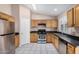 Well-equipped kitchen with stainless steel appliances and light wood cabinetry at 9135 W Hazelwood St, Phoenix, AZ 85037