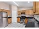 A kitchen featuring stainless appliances and light wood cabinetry at 9135 W Hazelwood St, Phoenix, AZ 85037