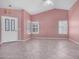 Open living room featuring neutral walls, tile floors, vaulted ceiling and natural light from window shutters at 9135 W Hazelwood St, Phoenix, AZ 85037