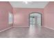 Spacious living area with tile flooring, arched entryway and abundant natural light at 9135 W Hazelwood St, Phoenix, AZ 85037