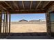 Framed view showcasing a large, flat backyard, enclosed by a block wall, presenting a blank canvas for landscaping at 9532 W Parkway Dr, Tolleson, AZ 85353
