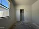 A bright bedroom featuring a window, closet and blank canvas for new owners to customize at 9532 W Parkway Dr, Tolleson, AZ 85353
