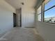Bright bedroom with large window and closet with sliding doors; freshly painted and ready at 9532 W Parkway Dr, Tolleson, AZ 85353