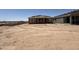 New home under construction with framing, roofing and exterior progressing. Large dirt lot at 9532 W Parkway Dr, Tolleson, AZ 85353