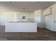 Open-concept kitchen area with white cabinetry, open space, and tile flooring at 9532 W Parkway Dr, Tolleson, AZ 85353