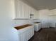 New kitchen featuring crisp white cabinetry and space for all new countertops and appliances at 9532 W Parkway Dr, Tolleson, AZ 85353