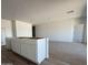 Open-concept kitchen island area with white cabinetry and space for all new appliances at 9532 W Parkway Dr, Tolleson, AZ 85353