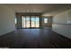 Open living space features tile flooring, a large sliding glass door, and neutral paint, awaiting your personal touch at 9532 W Parkway Dr, Tolleson, AZ 85353