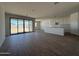 Spacious living room with wood-look tile flooring, large glass sliding doors to backyard at 9532 W Parkway Dr, Tolleson, AZ 85353