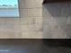 Detailed shot of the kitchen's gray brick tile backsplash at 9544 W Parkway Dr, Tolleson, AZ 85353