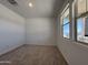 Cozy bedroom with plush carpet, natural light, and a neutral color scheme at 9544 W Parkway Dr, Tolleson, AZ 85353