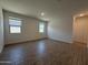An empty bedroom with tiled floors and two windows at 9544 W Parkway Dr, Tolleson, AZ 85353