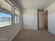 Bright bedroom featuring carpet, a window, and a sliding door closet at 9544 W Parkway Dr, Tolleson, AZ 85353