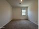 Clean bedroom with a window and neutral walls at 9544 W Parkway Dr, Tolleson, AZ 85353