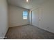 Bedroom featuring a closet with carpet floors and a window at 9544 W Parkway Dr, Tolleson, AZ 85353