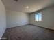 Bright, carpeted bedroom has neutral paint with natural light from window at 9544 W Parkway Dr, Tolleson, AZ 85353