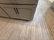 Close up of wood look tile flooring and gray kitchen cabinets at 9544 W Parkway Dr, Tolleson, AZ 85353