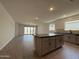 Open-concept kitchen featuring an island and sleek countertops at 9544 W Parkway Dr, Tolleson, AZ 85353
