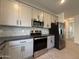 Well-appointed kitchen with stainless appliances and modern gray cabinetry at 9544 W Parkway Dr, Tolleson, AZ 85353