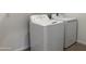 A laundry room equipped with GE washer and dryer at 9544 W Parkway Dr, Tolleson, AZ 85353